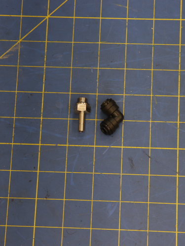 Screw type L-connector 6-1/8 INOX DUAL part on blue measuring grid mat