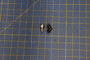 Screw type L-connector 6-1/8 INOX DUAL part on blue measuring grid mat