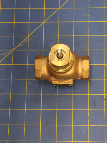 SP Belimo Valve 5.5Cv Bronze Body, SS on a blue measuring grid mat